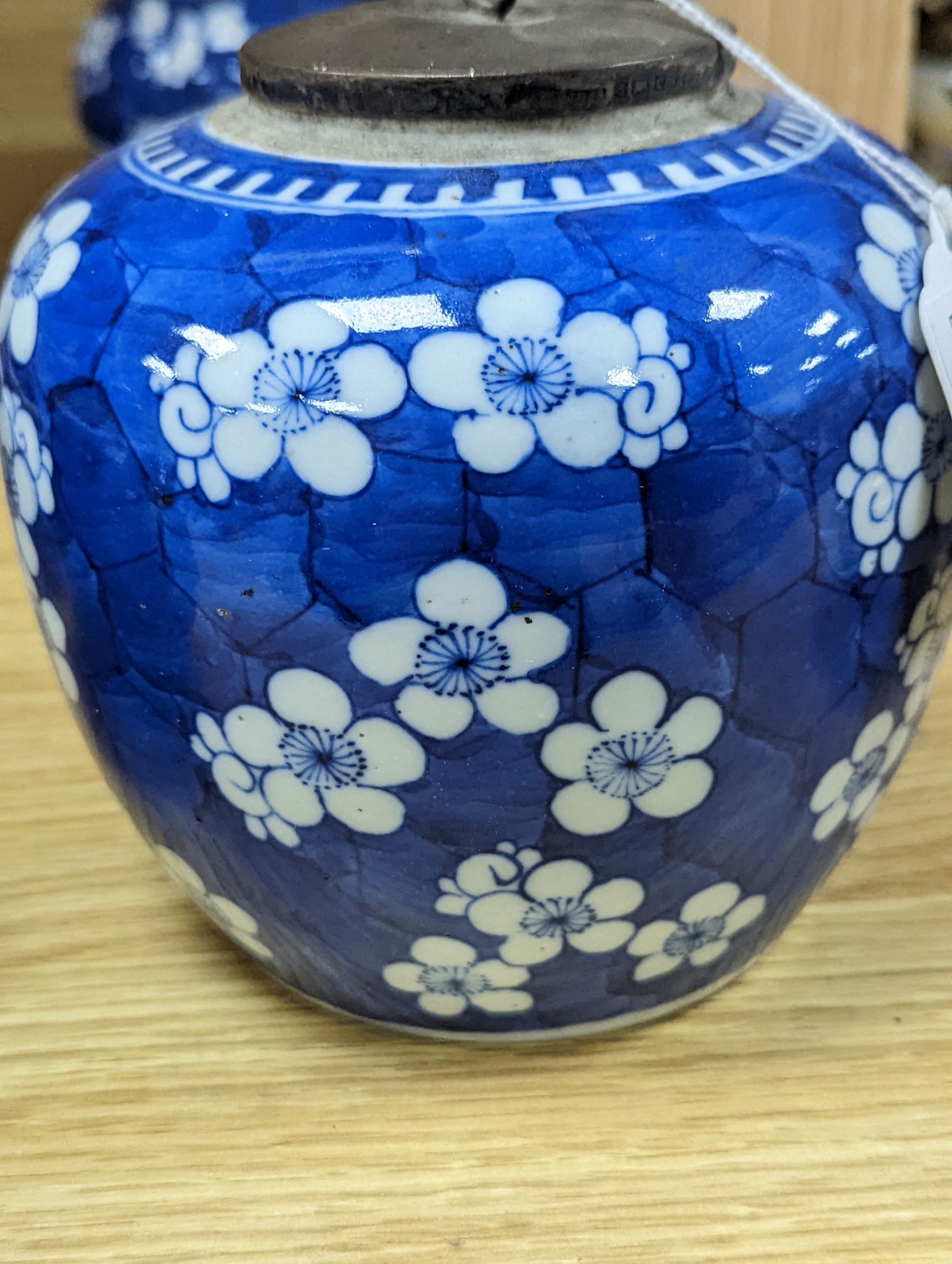 Three Chinese blue and white prunus decorated jars and covers, 19th/20th century, with four character marks 18cm